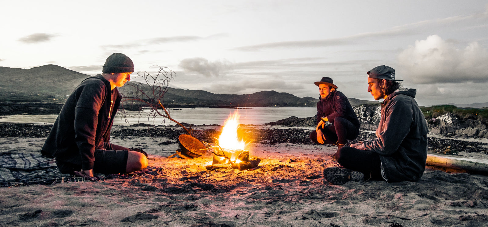 Friends sitting around a campfire at a fire pit during COVID19 socially distancing.