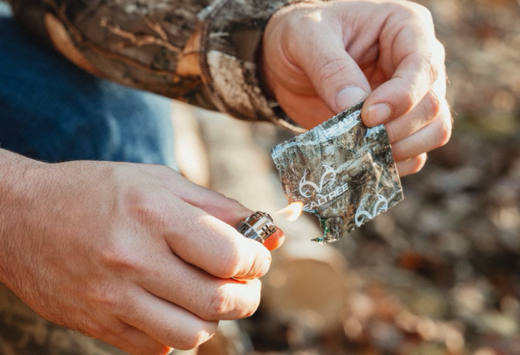 Realtree Fire Starters being used on outing trip wearing hunting camouflage - best new outdoor products for holiday gifts guide